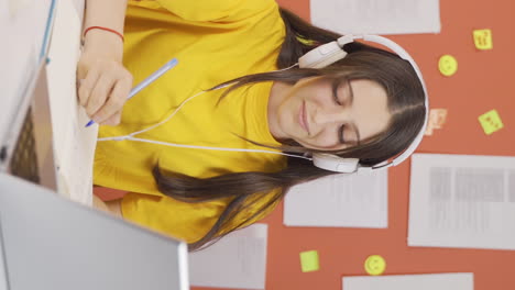 Vertical-video-of-Girl-child-listening-to-music-with-headphones-at-home